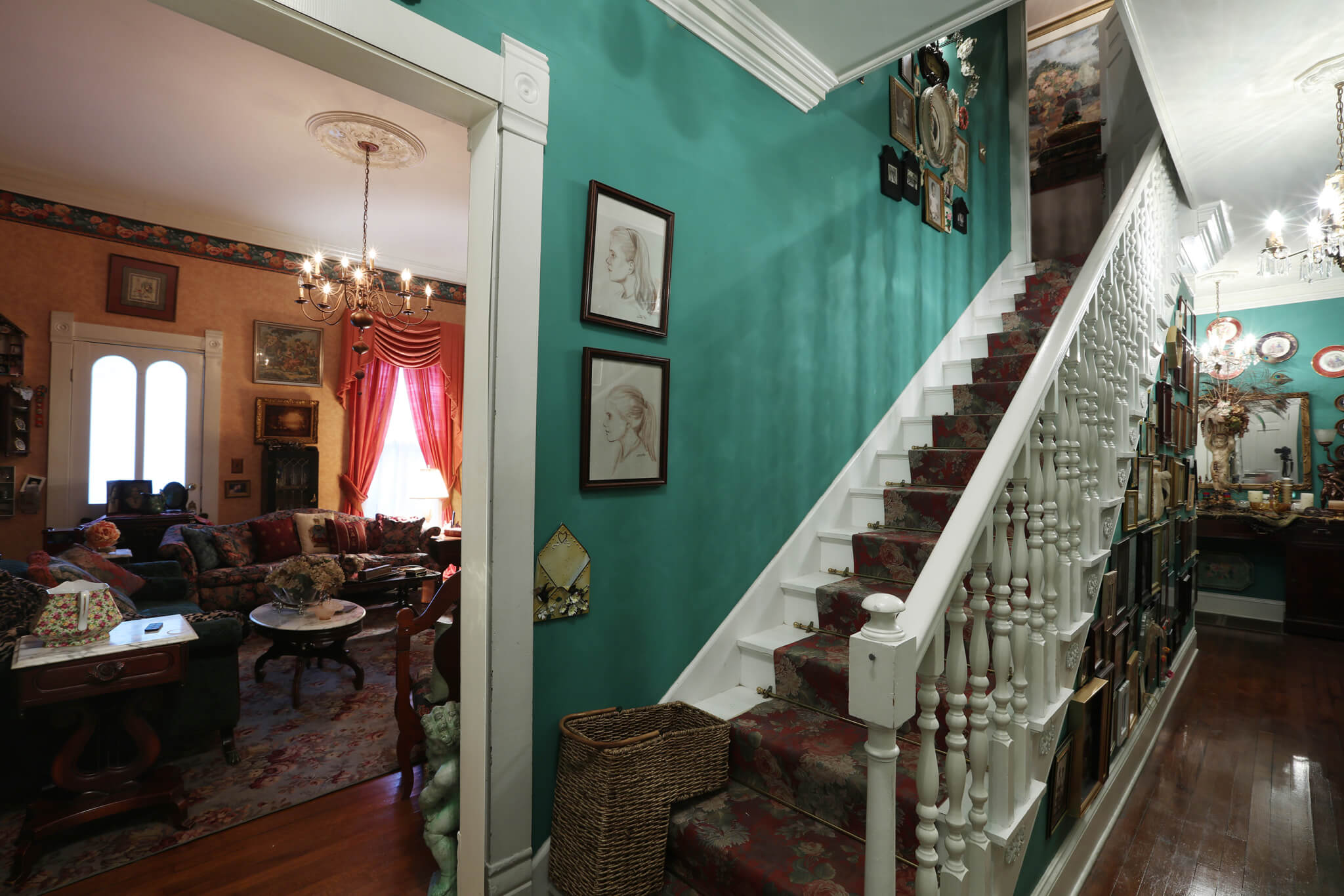 Stairs leading upstairs against a green wall and Living Room on the left side